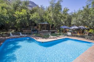 a swimming pool with a playground and a swing at La Bella Durmiente in San Alfonso