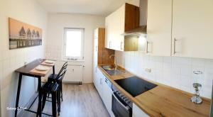 a kitchen with a counter and a table and chairs at M & M Serviced Apartment in Grafenwöhr