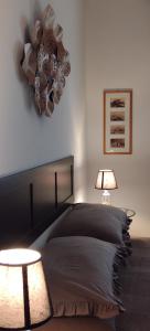 a bedroom with a large bed and a chandelier at A casa di Peppino Villa Greco in Tindari