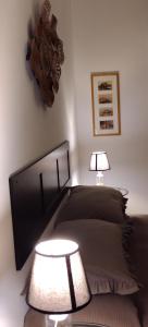 a bedroom with a bed and a table with a lamp at A casa di Peppino Villa Greco in Tindari