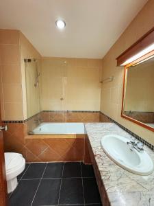 a bathroom with a sink and a tub and a toilet at Jade Tower in Chiang Mai +39 photos