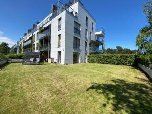 a large building with a large yard in front of it at Apartament Dani-Apart in Gdańsk