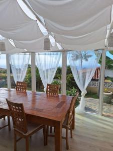 a dining room table with chairs and a white tent at Casa Betania ocean view in La Orotava +21 photos