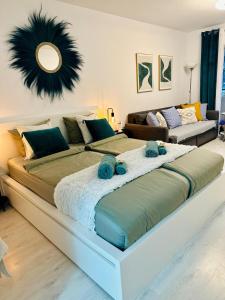 a large bed with two blue towels on top of it at Studio Los Cristianos Atlantic View in Los Cristianos +26 photos