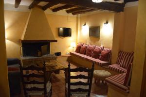 a living room with a couch and a fireplace at Masia d'Els Plans in Vidrá
