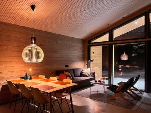 a living room with a table and a couch at Villa Alveus - Nordic design cabin in Ylläs in Kolari