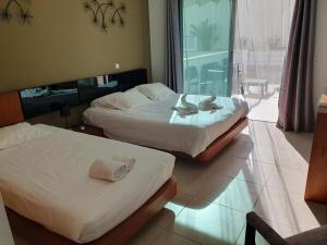 two beds in a hotel room with swans on them at Magnifique Duplex avec piscine en bord de mer in Olhos de Água +23 photos