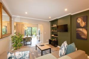 a living room with a couch and a table at Ellefsen 134 Golf Paradise - NEWLY RENOVATED! in Langebaan
