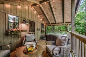 a screened in porch with a table and chairs at Light'n Bug Bungalow in Townsend