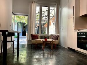 a kitchen with a table and a couch and a table at Studio Richard in Antwerp +5 photos