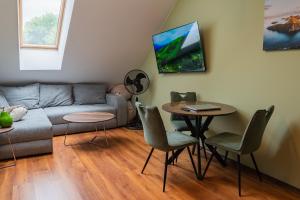 a living room with a couch and a table at Alpine Retreat Maisonette in Bansko