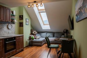 a living room with a couch and a table at Alpine Retreat Maisonette in Bansko +9 photos