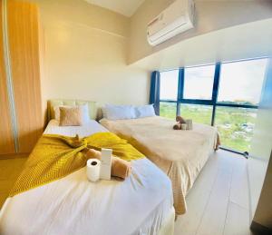 Katil atau katil-katil dalam bilik di Cozy 2br with pool and beach access