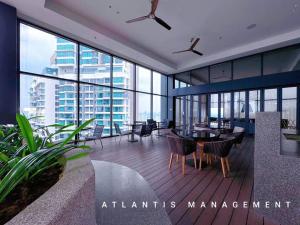 a large room with tables and chairs in a building at Midvally Mega Mall, Link With The Garden, KL ECO City By Atlantis Management in Kuala Lumpur