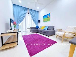 a living room with a couch and a purple rug at Midvally Mega Mall, Link With The Garden, KL ECO City By Atlantis Management in Kuala Lumpur