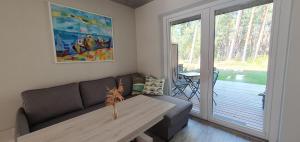 a living room with a couch and a table at Apartamentas Preila in Neringa