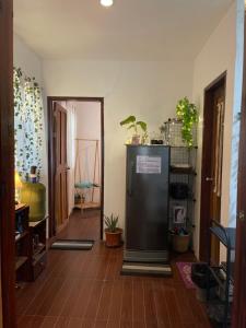 a hallway with a refrigerator in a room at StayOver Villa at Travellers Beach Resort in General Luna