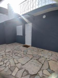an empty room with a staircase and a stone floor at Casa Estoril in Livramento