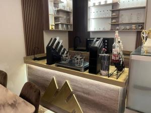 a bar with bottles of alcohol on a counter at فندق أجنحة ألفية Hotel AJENHA ALFIA in Medina