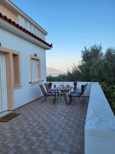 two children sitting at a table on a patio at Olive Τree Ηouses in Votsalákia +26 photos