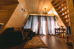 a living room with a couch and a table at Cottage lima in Kutaisi