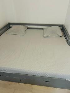 a bed with two pillows on top of it at Paris apertment in Paris
