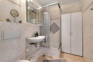 a bathroom with a shower and a sink and a toilet at Ferienappartement Holm Ostsee in Brasilien +14 photos