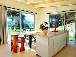 a kitchen with a table and a large window at The Hidden Spring in Wanaka