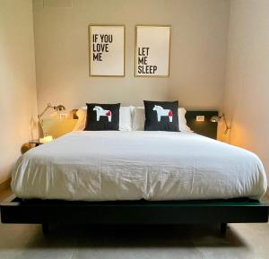a bedroom with a large white bed with two pillows at STADLERINO - Tiny Loft in Venice in Marghera