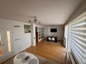 a living room with a table and a television at Villa Sunny side Sarajevo in Sarajevo
