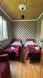 a room with two beds in a room at Farielli Guesthouse in Mestia