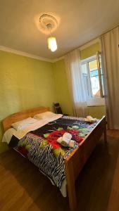 a bedroom with a bed with a zebra blanket on it at Farielli Guesthouse in Mestia +8 photos
