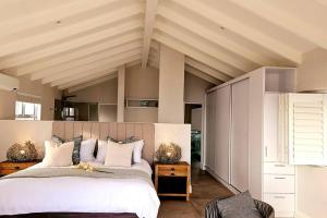 a bedroom with a large bed in a room at Villa Swart in Stompneusbaai +90 photos