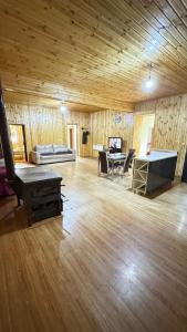 a large living room with a piano and a table at Farielli Guesthouse in Mestia