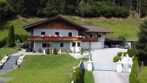 a house with a fence and a yard at Unterbleiwanghof in Radstadt