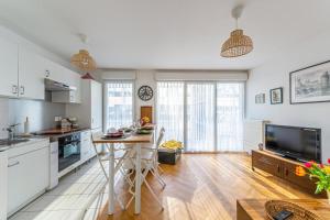 Una cocina con una mesa y un comedor. en Le Korrigan de Massy, en Massy