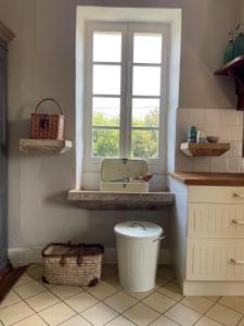 a bathroom with a sink and a toilet and a window at Maison de Famille Les Tourelles in Tour-de-Faure