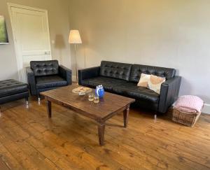 a living room with a couch and a coffee table at Maison de Famille Les Tourelles in Tour-de-Faure