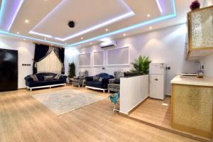a large living room with couches and a refrigerator at شاليهات درة المئة in Ḩajlah