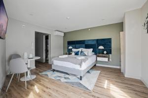 a bedroom with a bed and a table and chairs at Cottage Suites in Middletown