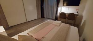 a small room with a bed with two chairs at Sunny room 1 in Dinkelsbühl