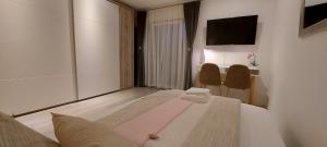 a hotel room with a bed and a table at Sunny room 1 in Dinkelsbühl +25 photos