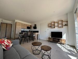 a living room with a couch and a television at La Villa d Isa in La Motte