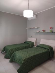 Postel nebo postele na pokoji v ubytování Casa Vacanze Borgo Garibaldi