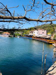 uma vista para um rio com um cais e edifícios em Pousada das estrelas em Florianópolis