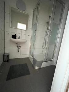 a bathroom with a shower and a sink at Doppelzimmer mit Bad-TV-Külschrank 9 in Meine +10 photos