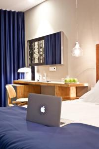 a hotel room with a laptop on a bed at Ocean Drive Talamanca in Talamanca