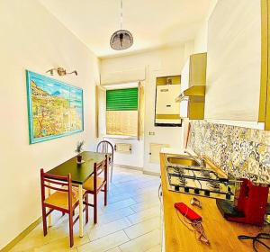 a kitchen with a table and a dining room at Essenza3 0 in Salerno