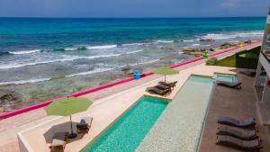 an overhead view of a swimming pool and the ocean at Playa Norte Oceanfront Remote Work Plus Concierge in Isla Mujeres