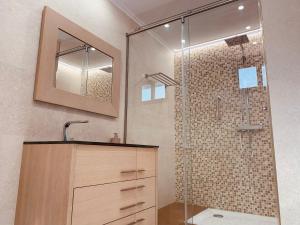 a bathroom with a shower with a sink and a mirror at A R Benjamín in Artana +42 photos